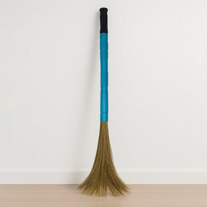 Close-up view of floor broom head with synthetic bristles
