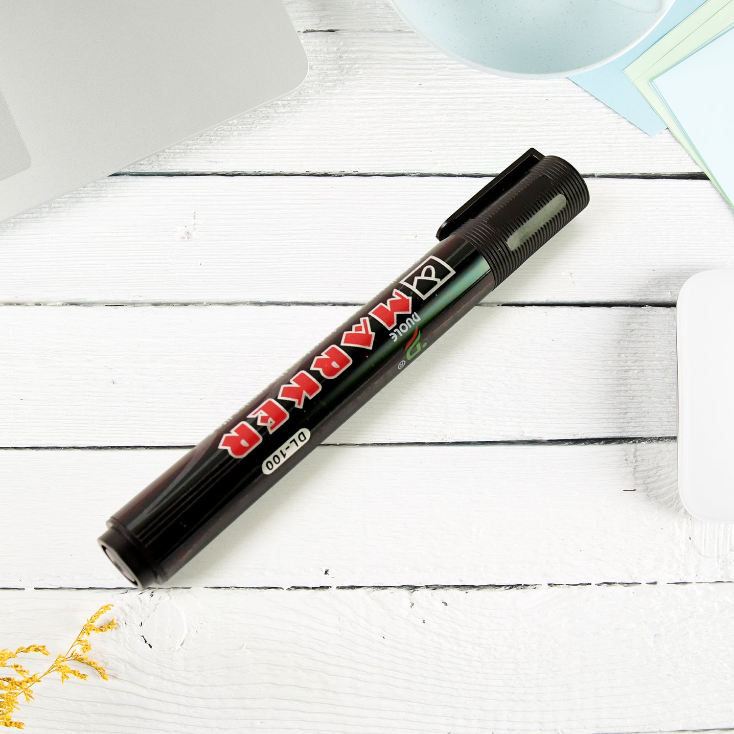 Black whiteboard marker writing clear black ink on whiteboard surface
