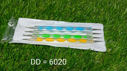 Hand holding nail art pen over palette for design.