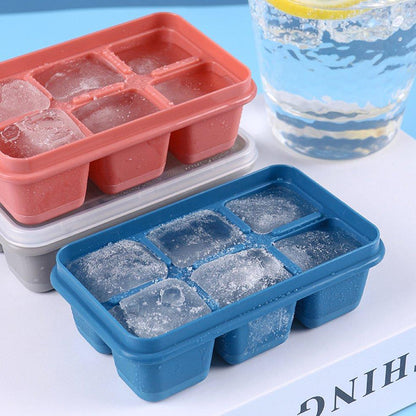 Flexible blue silicone ice tray with 6 grids, filled with water for freezing.