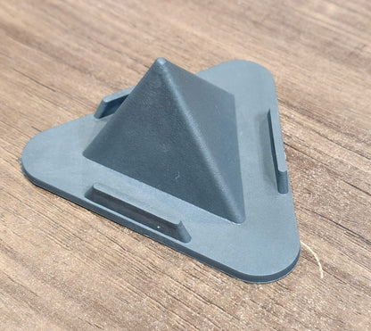 Grey pyramid mobile phone stand placed on office desk