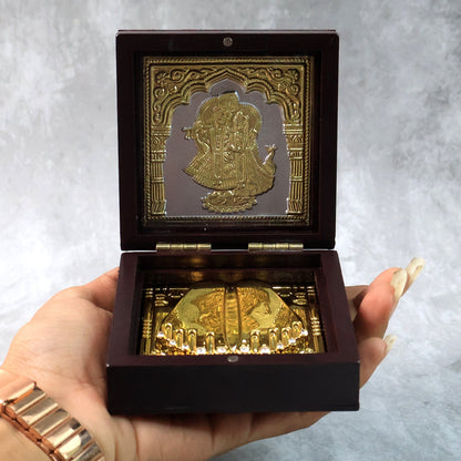 Video presenting golden Charan Paduka in wooden box used as devotional pooja accessory