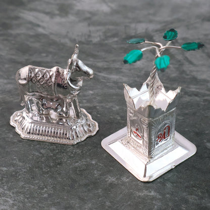Detailed silver-plated Kamdhenu cow and Tulsi plant pair with Swastik symbol for pooja