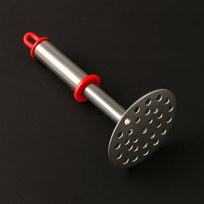 Close-up of wide mashing plate with precision-cut holes on potato masher