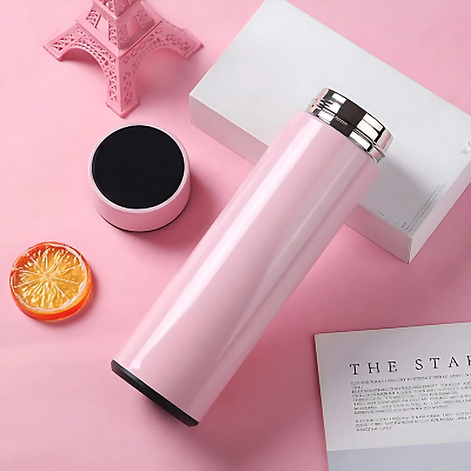 Sleek pink smart water bottle showing temperature on touch screen