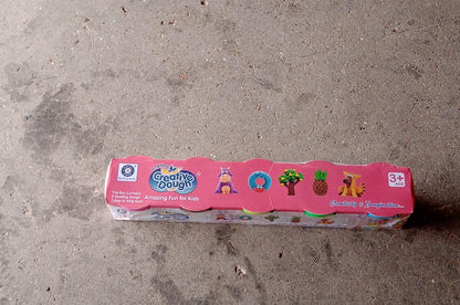 A child's hands shaping colourful non-toxic dough clay, promoting imaginative play.