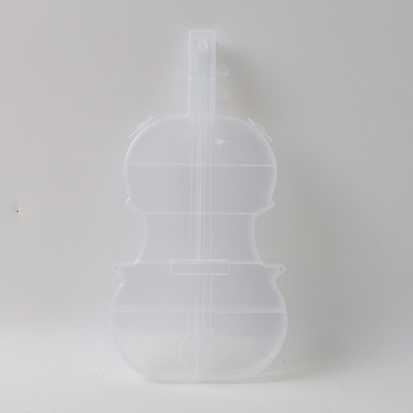 Compact violin-shaped storage container for small accessories